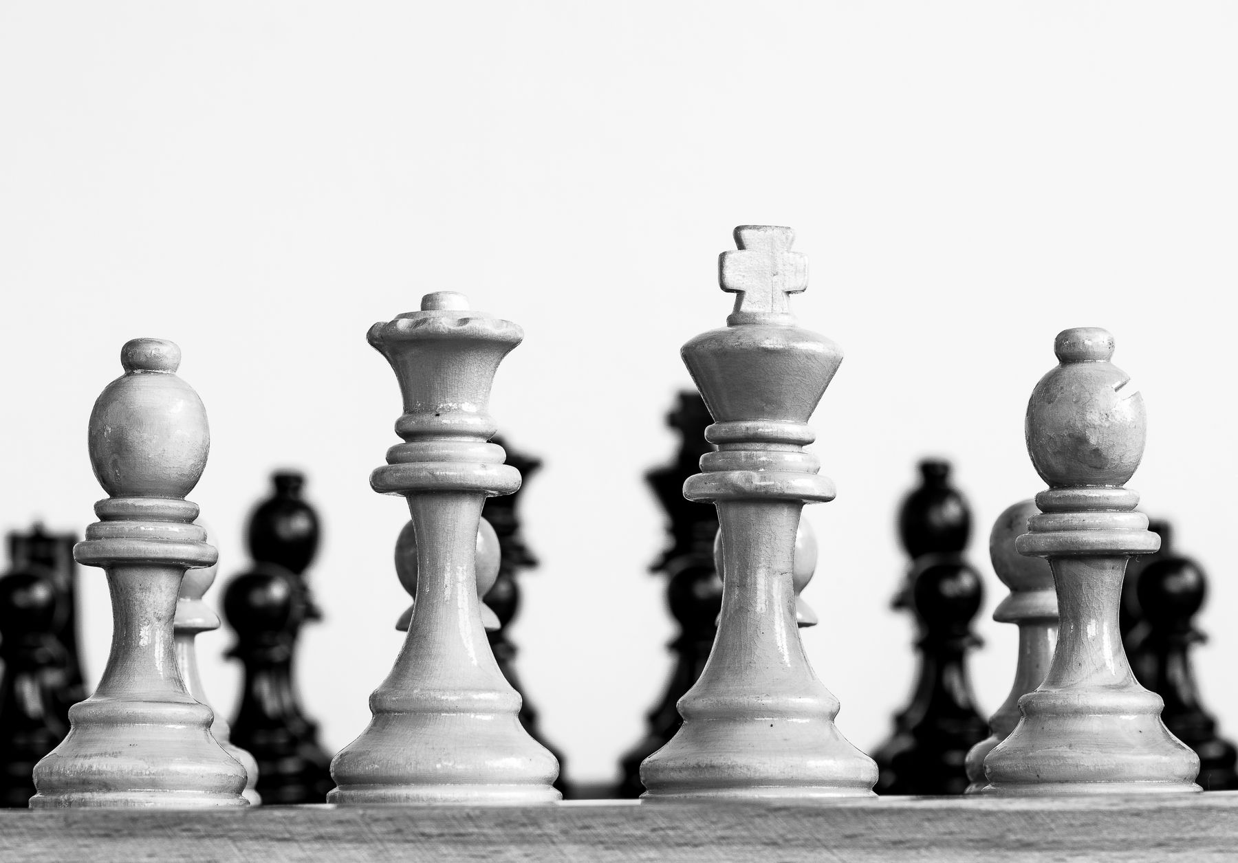 Black and white photograph of chess pieces on a chessboard